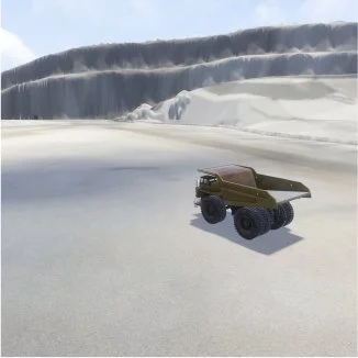 Remote control dump truck on a sandy landscape with cliffs in the background.