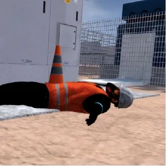 Simulation of a construction worker lying on the ground next to a traffic cone and a building site fence.