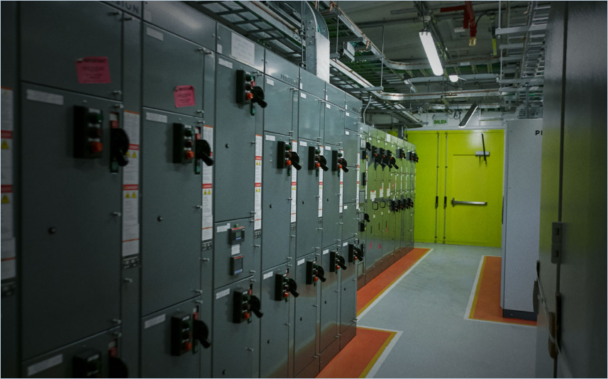Industrial electrical VR Simulated control room with grey panels and safety equipment.