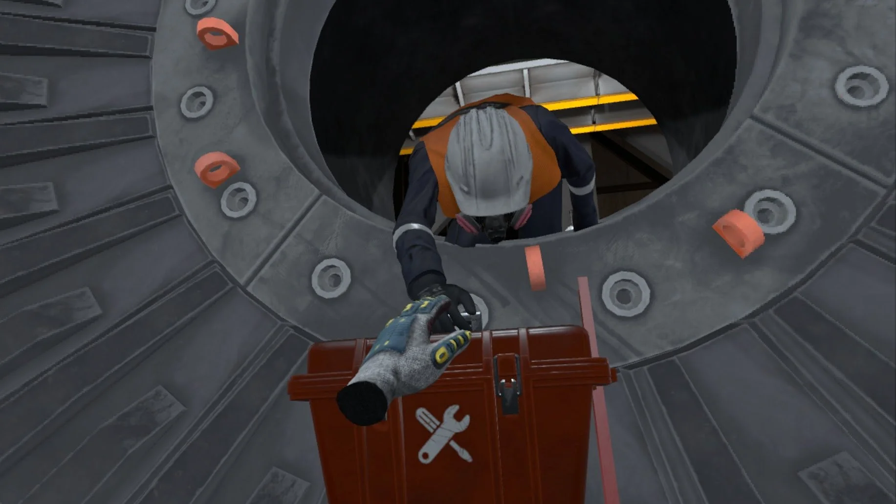 Worker wearing safety gear reaching through industrial machinery to grab a tool case.