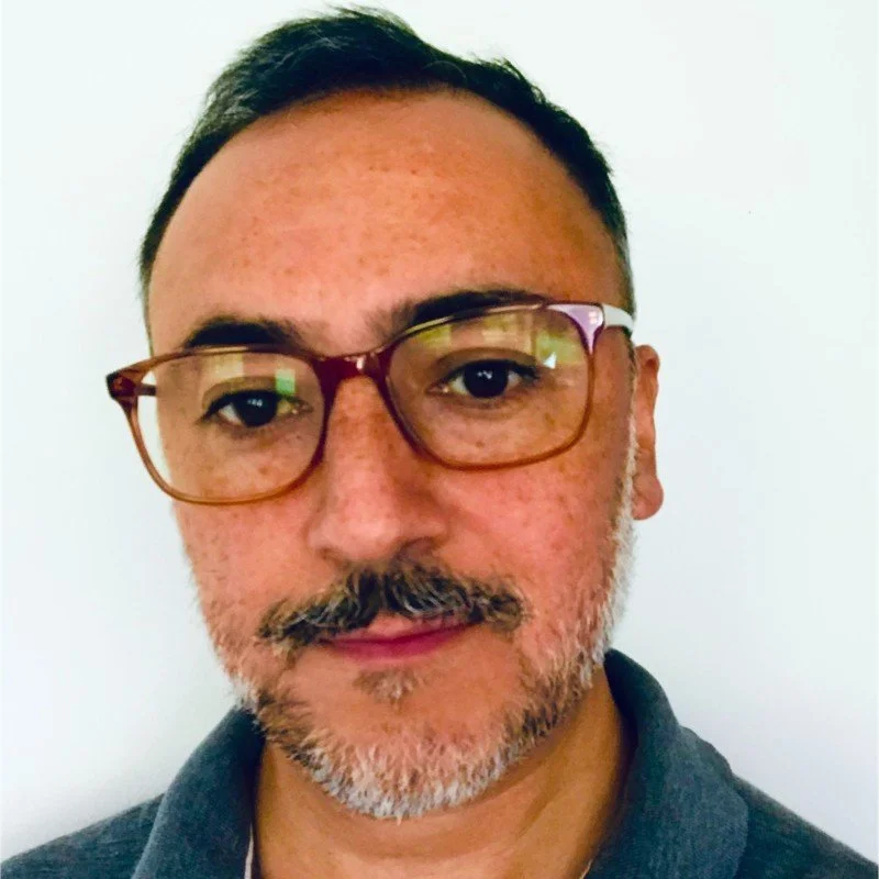 Patricio Vargas, wearing glasses with short hair and a light beard, against a plain background.