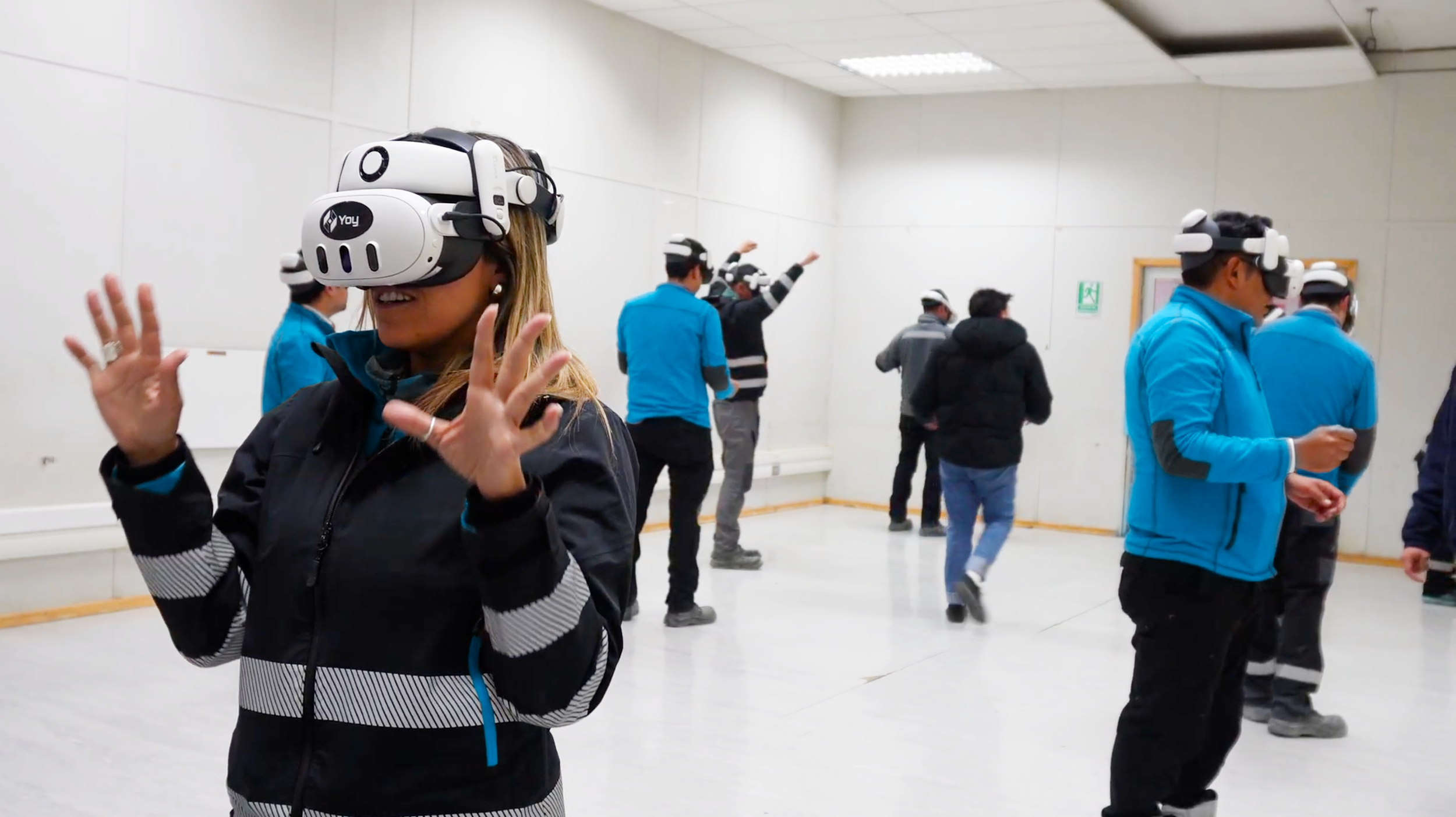 Group of people using virtual reality headsets in a room.